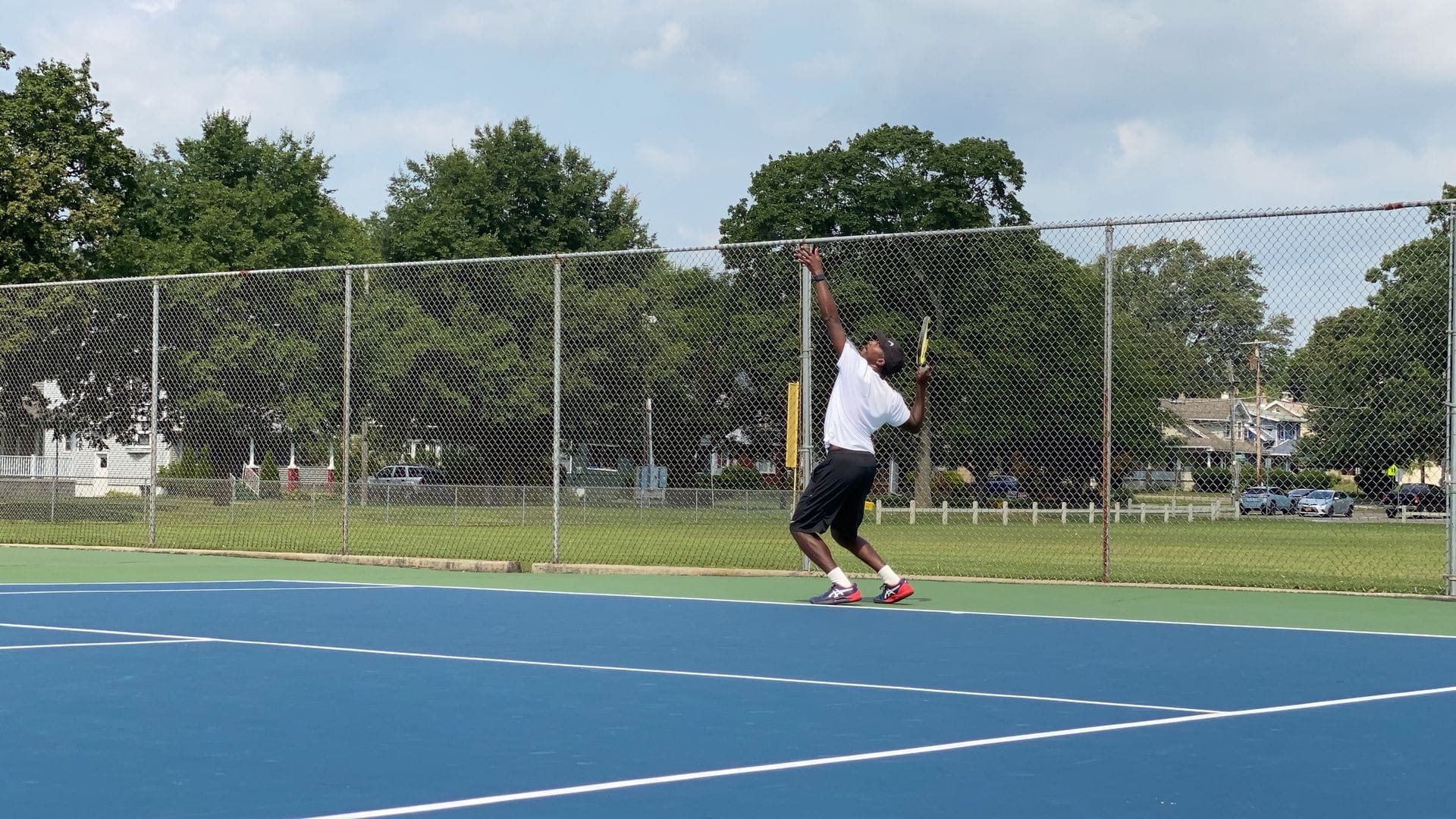 Ryan Davis serving on a hard court in Binghamton
